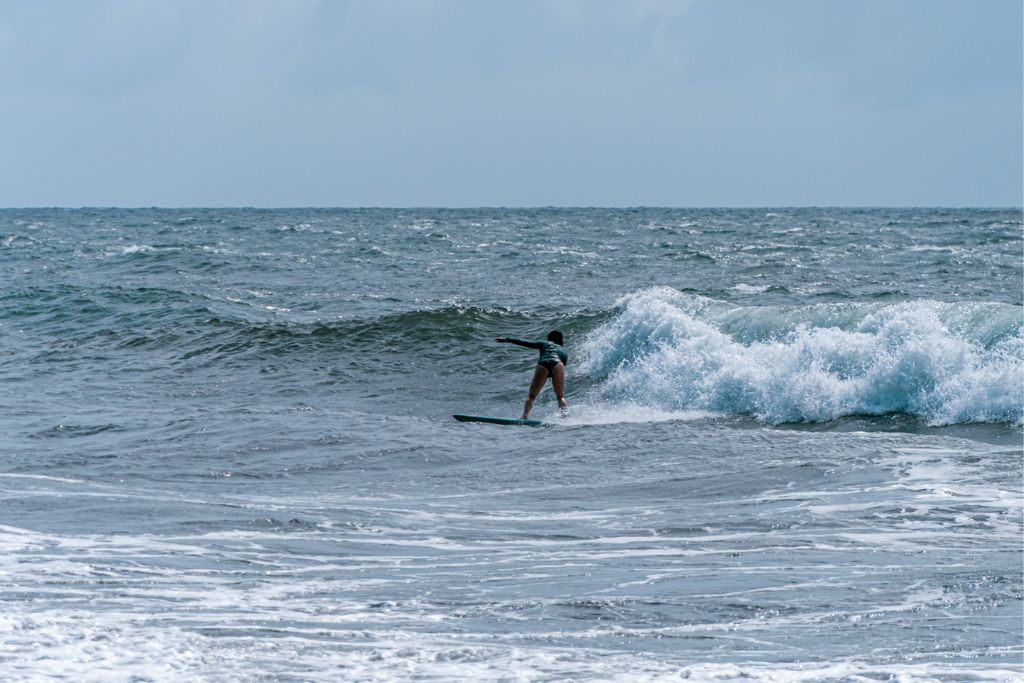A picture of Kristin surfing in Tahiti at a smaller break called Papenoo.