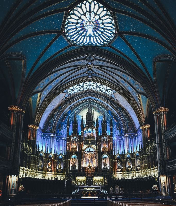 A picture of the remarkable interior of Notre-Dame Basilica. This building is part of Old Montreal and is a must visit for your 5 days in Montreal Itinerary.