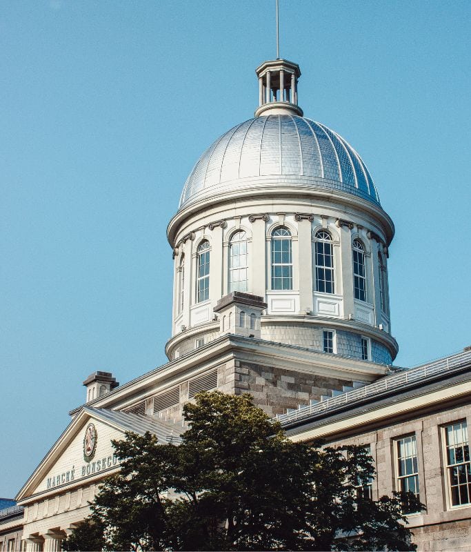A picture of the Bonsecours Market Building in Montreal's Old Town. Make sure to add browsing the shops at the Bonsecours Market to your 5 days in Montreal itinerary as it's always a fun way to see and support the work of local artisans in Canada.