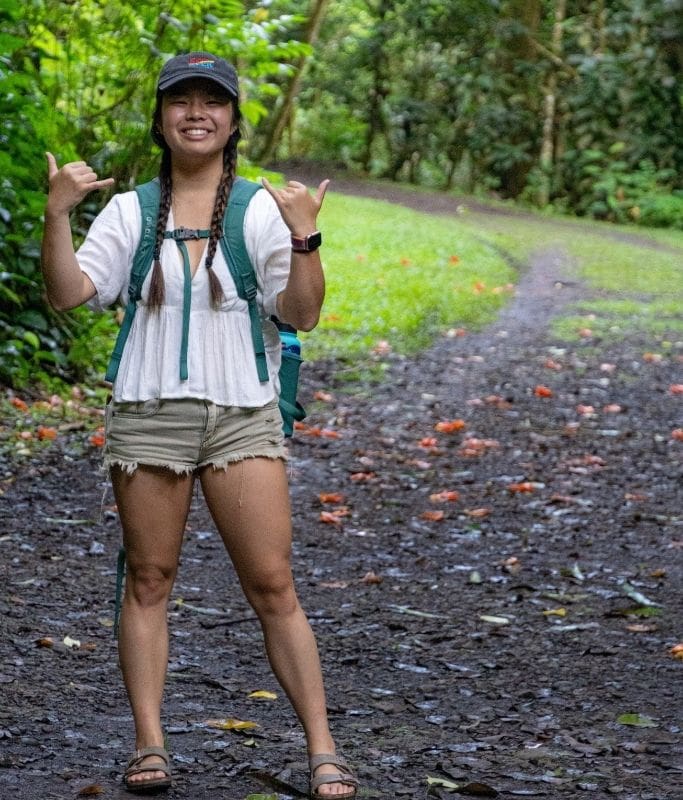 A picture of Kristin with her backpack and wearing Birkenstocks while hiking through Fautaua Valley.