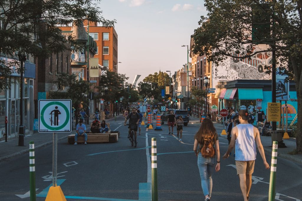 A picture of Mile End, which is an area of Montreal with lots of quicky small shops. They close the street off to traffic during summer months, making it a convenient pedestrian street.