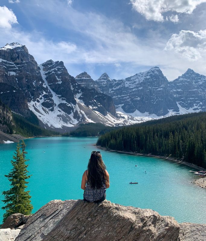 A picture of Kristin looking at Moraine Lake and its surrounding mountains from the top of Rockpile.