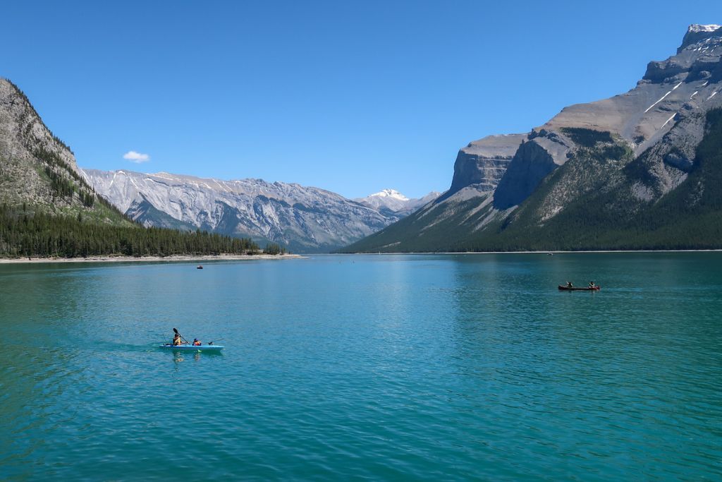 A picture of the beautiful landscape at Lake Minnewanka, our second stop on this 4-Day Banff Itinerary. The skies are clear and the water was a gorgeous turquoise blue.