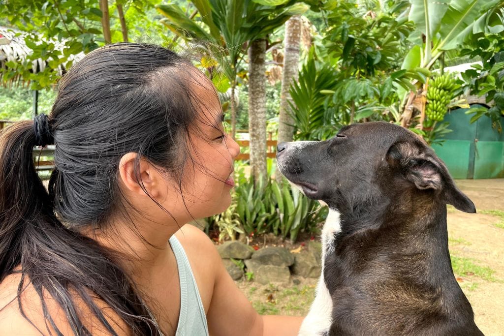 A picture of Kristin and the restaurant's dog at Moorea Tropical Garden.