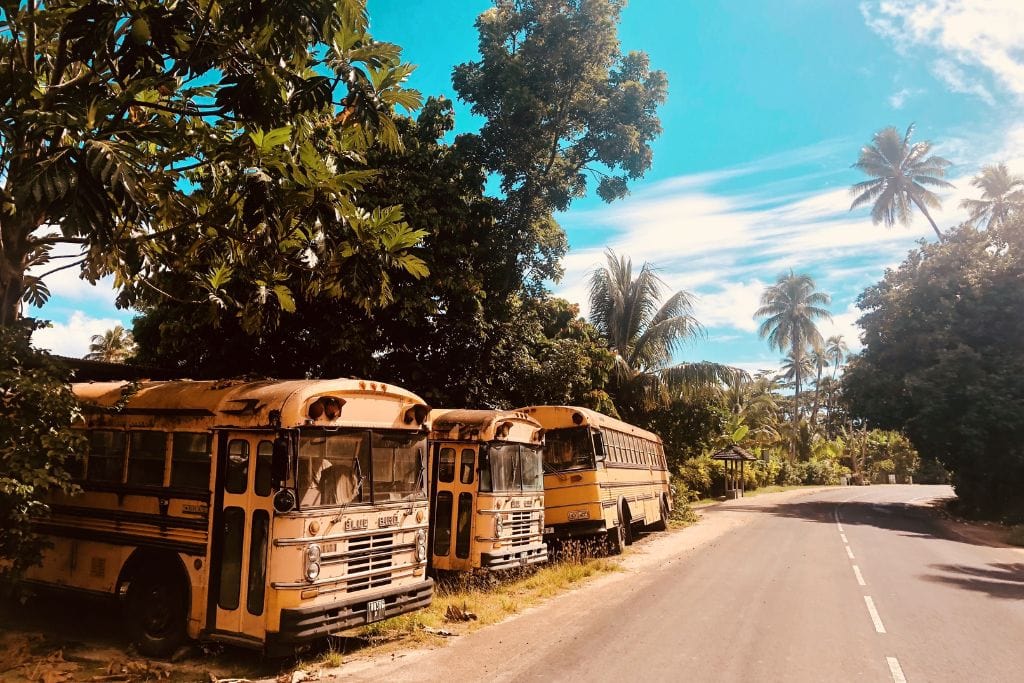 A picture of old buses on the side of the road in Tahiti. A neat little fact is that you can circumnavigate all of Tahiti in about 6 hours.