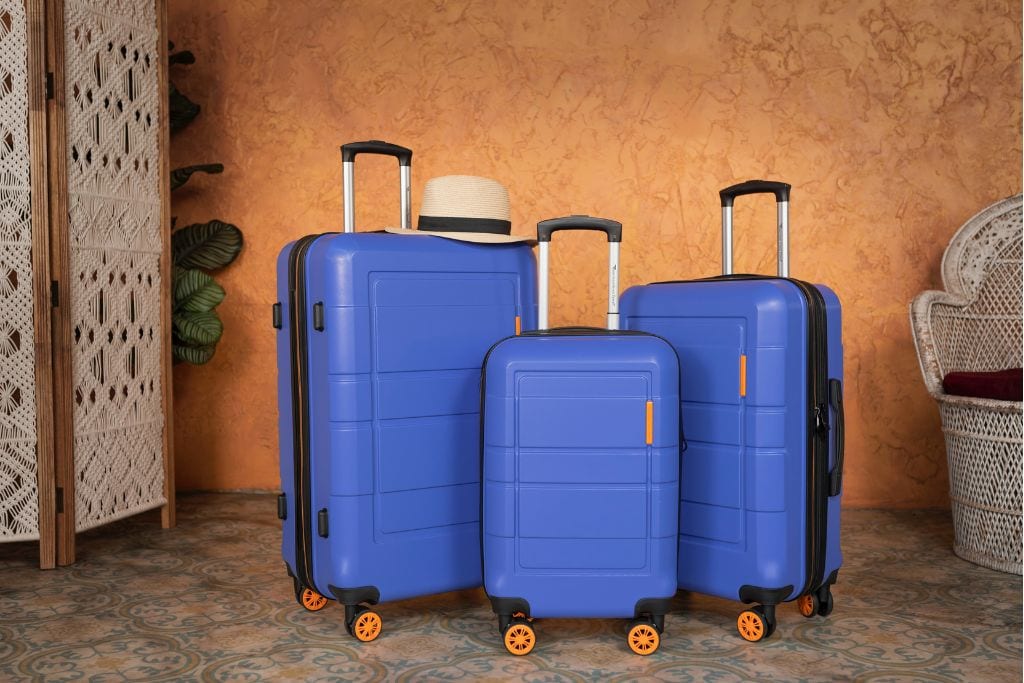 A picture of 3 blue suitcases of various sizes. A great tip for first time flyers is to always check the airline's luggage restrictions.