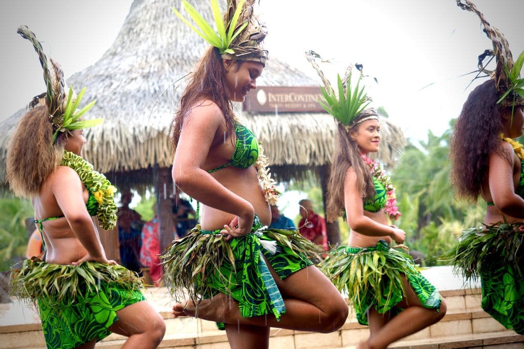 A picture of traditional Tahitian dancers. Tahiti is definitely worth visiting if learning about foreign cultures fascinates you!