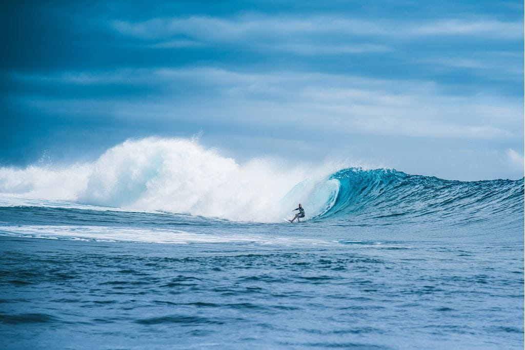 A picture of a local surfing the famous Teahupoo.