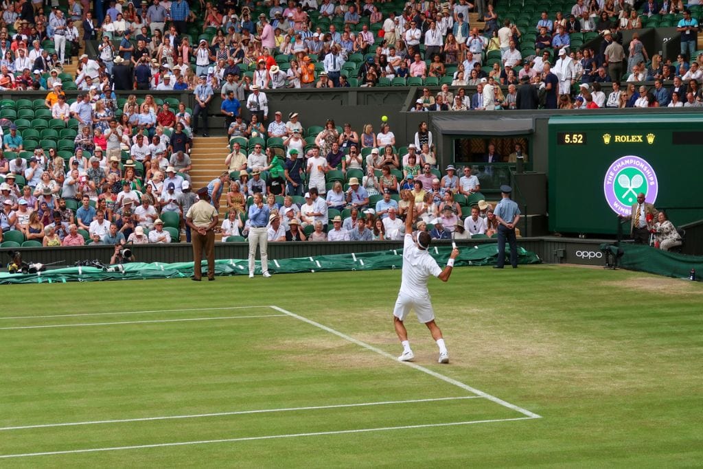 A picture of Roger Federer serving on Centre Court at Wimbledon