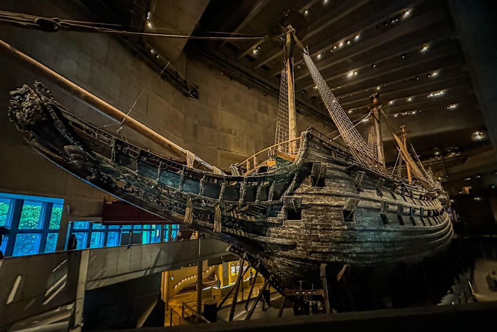 A picture of the front of the Vasa that you immediately see upon entering the museum. The ship is very dark.