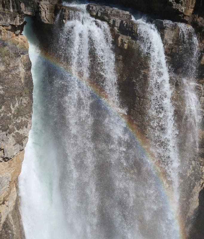 A picture of Upper Falls with a rainbow streaking across in Johnston Canyon.