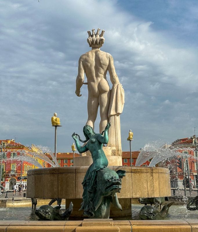 A picture of the backside of the statue and fountain in Place Massena.