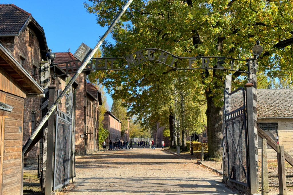 A picture of the infamous gate that reads, "Arbeit Macht Frei," which translates to "work sets you free" in German. On your day trip from Krakow to Auschwitz, you'll pass through the gate in the beginning of the tour.