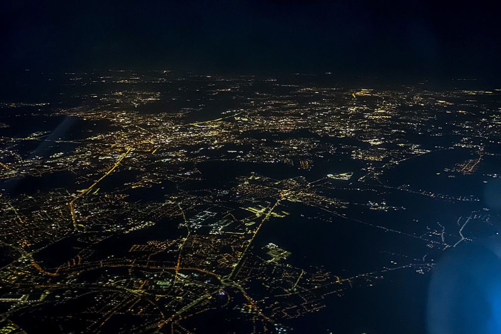A picture of the city lights of London while flying high above.