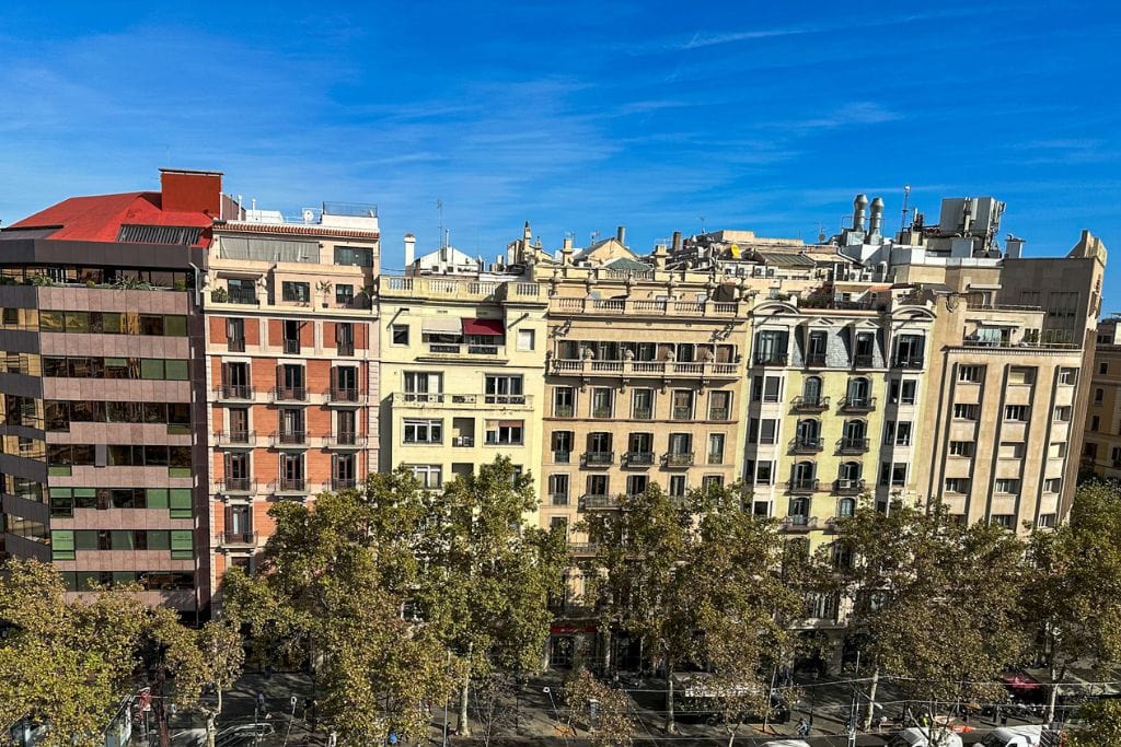 A picture taken from the roof terrace of Casa Batlló. You can see how bland and unremarkable the houses across the street are. This helps highlight the boldness and distinct architecture that makes Casa Batlló worth it for so many visitors. 
