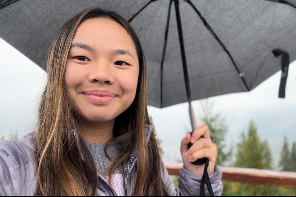 A picture of Kristin with her umbrella as it's raining in Zakopane. If you go on a Zakopane Tour from Krakow, make sure to bring an umbrella!