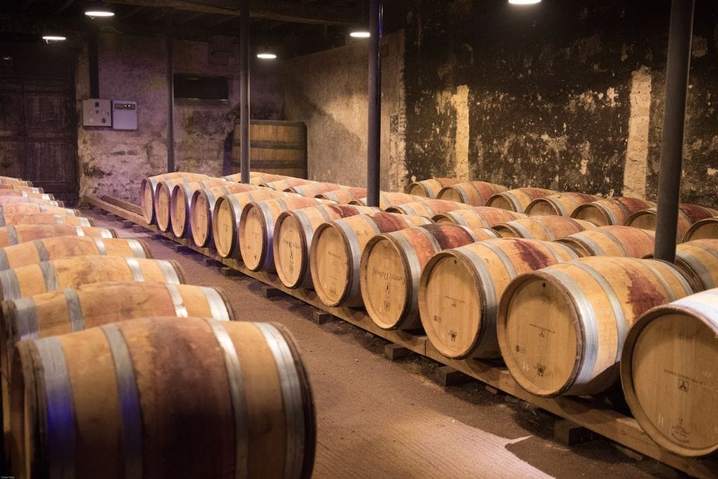 A picture of barrels of wine in a cellar.