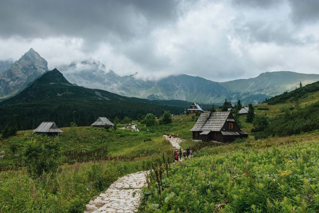 A picture of wooden cabins in the Tatra mountains. On a Zakopane Tour from Krakow, you'll pass by many wooden cabins that feature the Zakopane-style architecture.