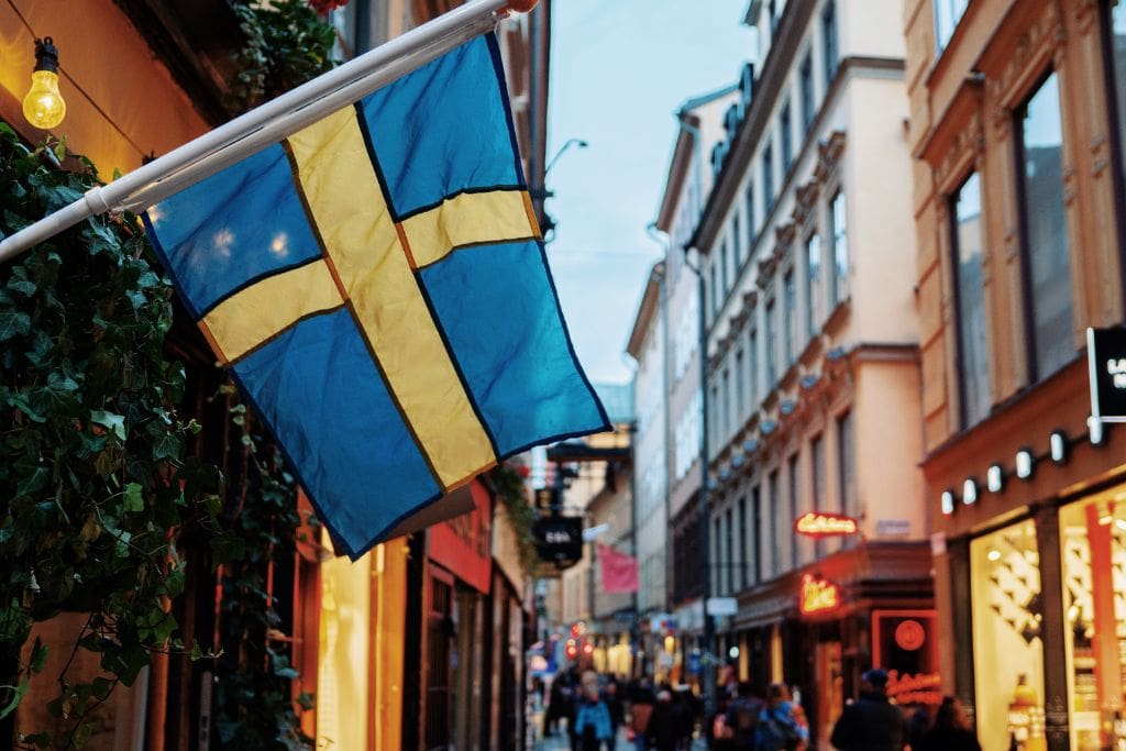 A picture of a Swedish flag flying in Stockholm's Old Town.
