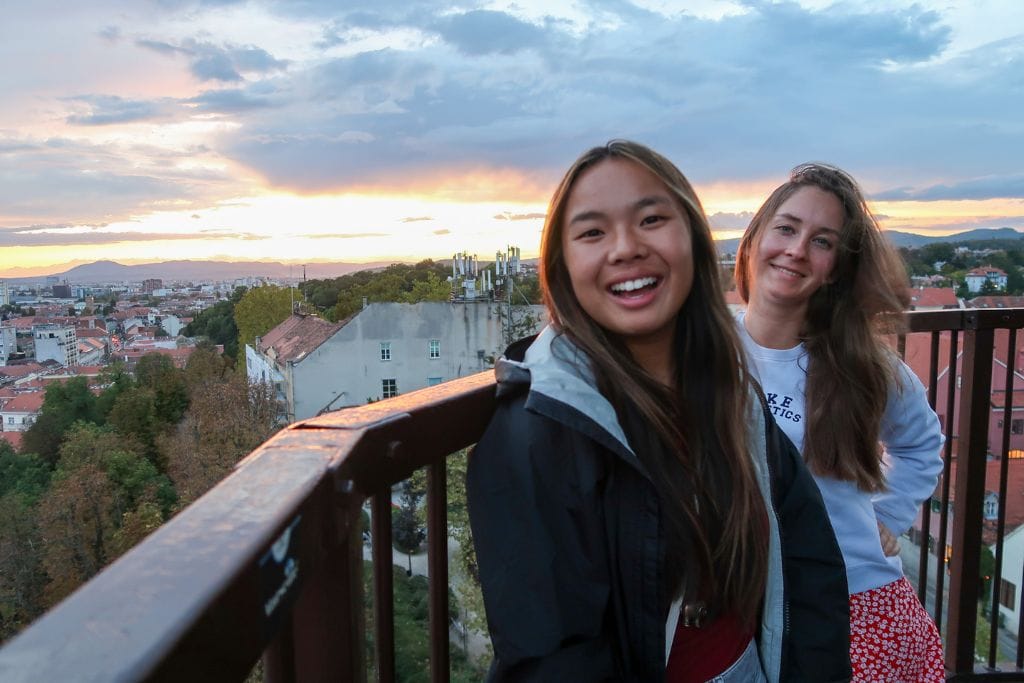 A picture of Kristin and her friend smiling during sunset at the top of Lotrščak Tower