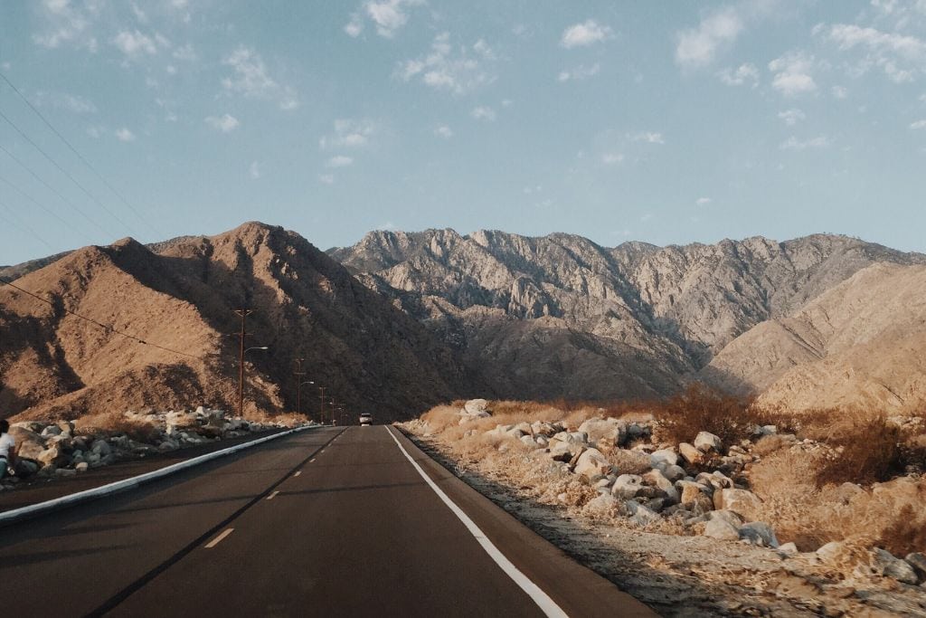 A picture of road leading to the Palm Desert mountains.