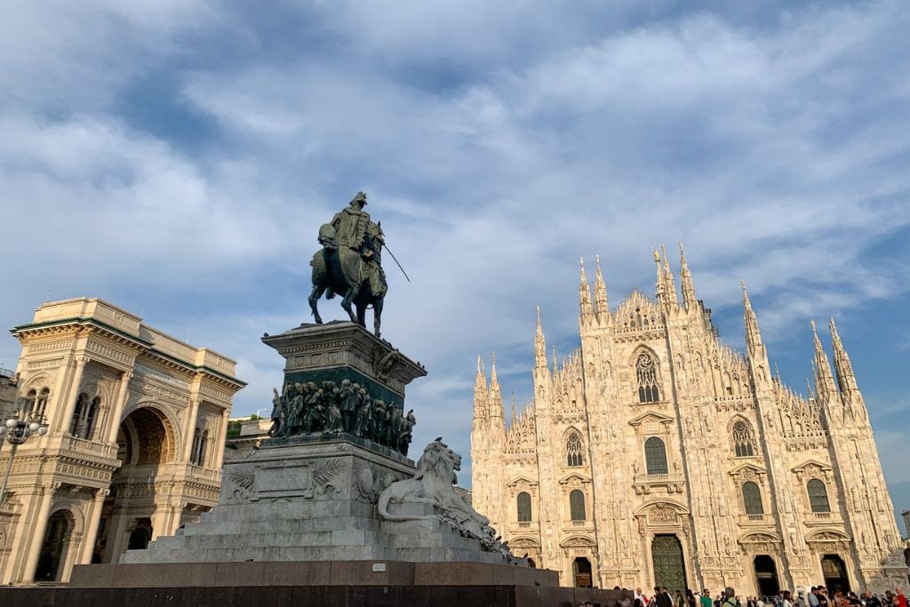 A picture of the main square in Milan. You can see the statue with a horse and rider in the center, the Duomo, and Galleria Vittorio Emanuele ii