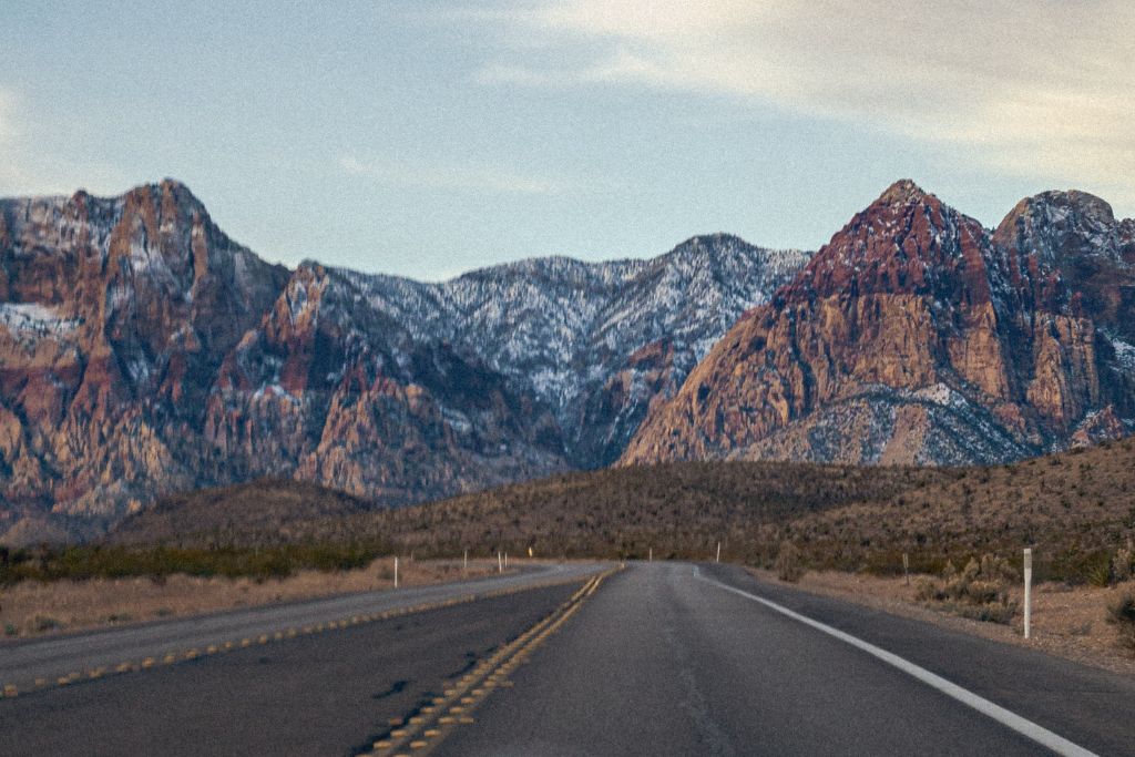 A picture of some of the mountains that can be seen in Red Rock Canyon. You can see the paved road that allows for bike tours to go through the canyon.