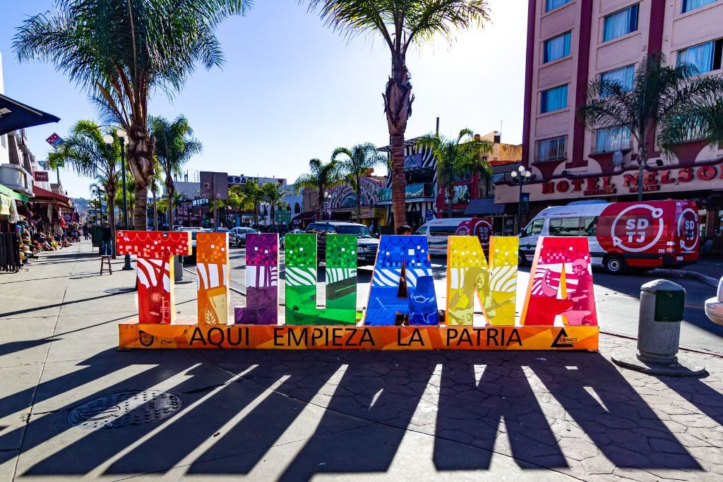 A picture of a colorful sign that spells Tijuana. A fun adventure you can do while in San Diego is a day trip to Tijuana, where you'll walk around.