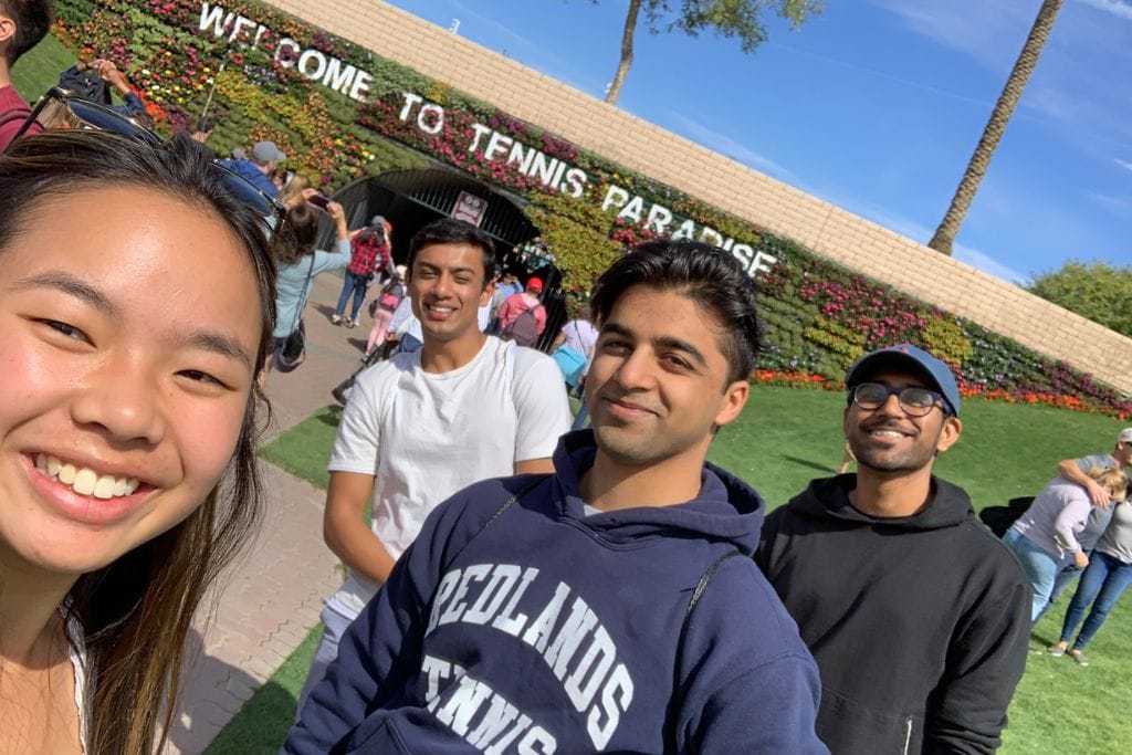 A group picture in front of the entrance to the Indian wells tennis tournament