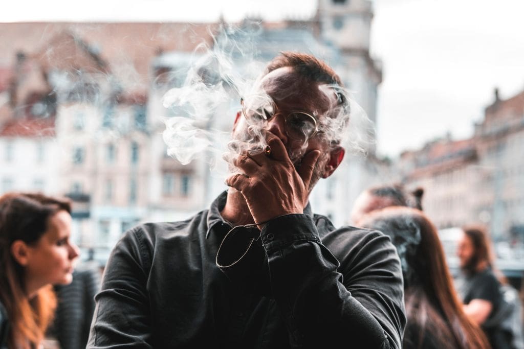 A picture of a man smoking. Smoking culture is huge in Paris and this was a major culture shock for me. Paris Syndrome is believed to be a severe form of culture shock.
