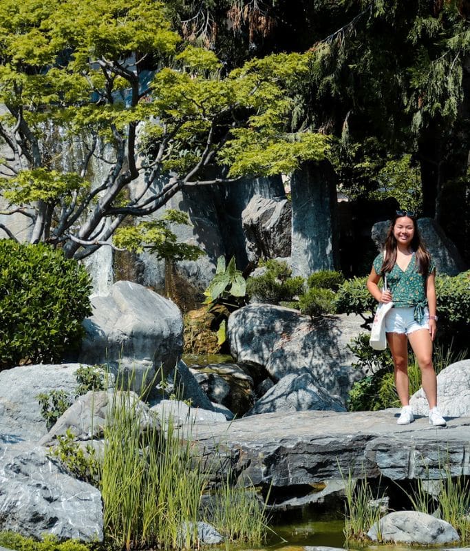 A picture of Kristin posing within the small Japanese Garden in Monaco.