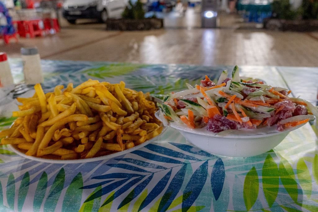 A bowl of french fries and a bowl of poisson cru. If you're a foodie or appreciate tasting the local flavors, consider doing one of the Tahiti food tours.