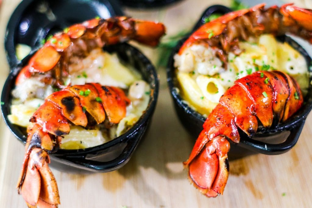 A picture of two dishes with lobster in them.