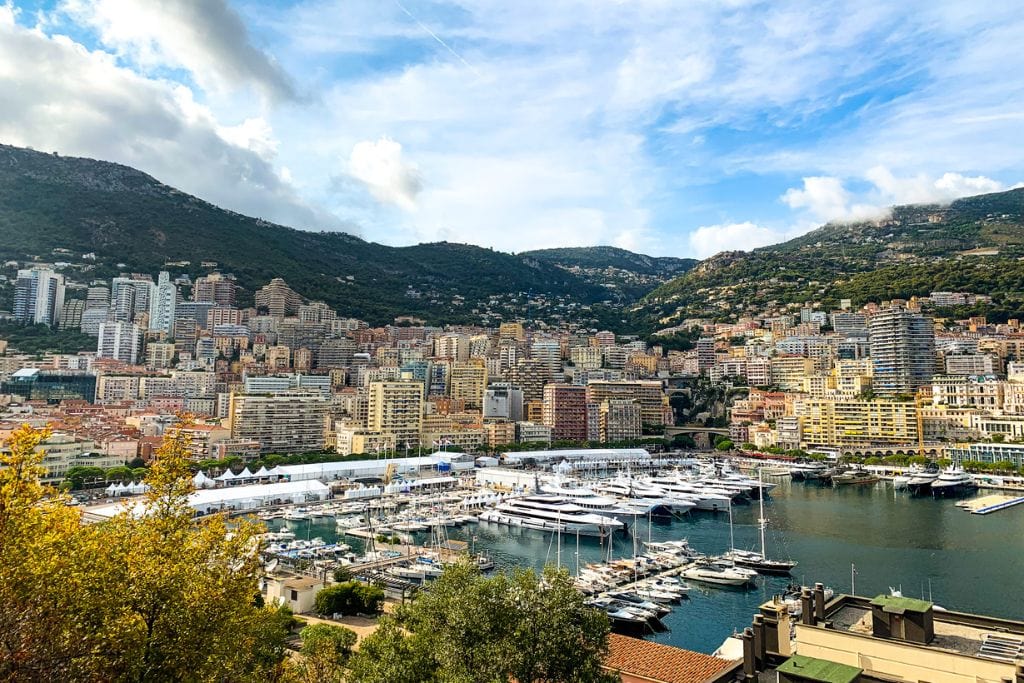 A picture of the surrounding mountains, Port Hercules and tall buildings in Monaco.