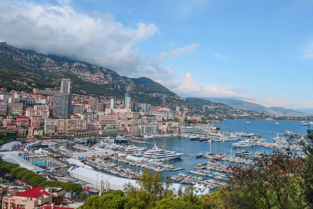 A picture of harbor and cityscape in Monaco. Like Monaco, the country between france and spain is a small principality.