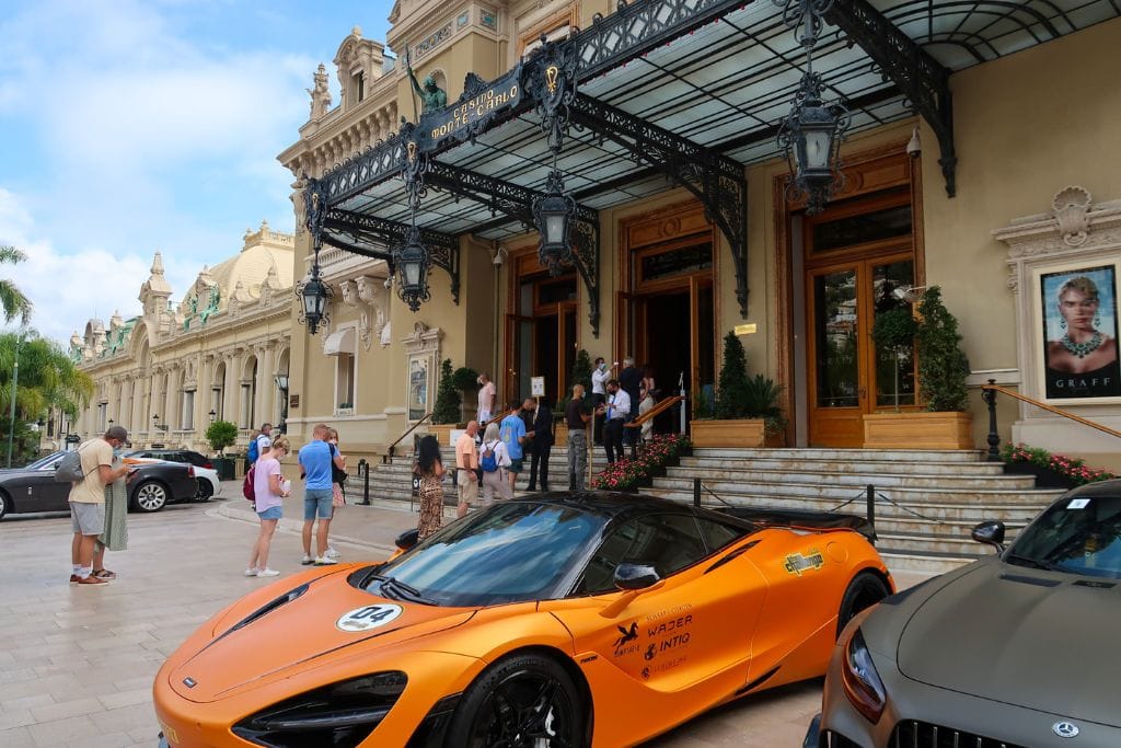 A picture of a luxury McLaren parked outside the Monte Carlo Casino. Monaco can definitely be expensive to visit if you splurge on luxury rental cars and gamble lots of money at the casino.
