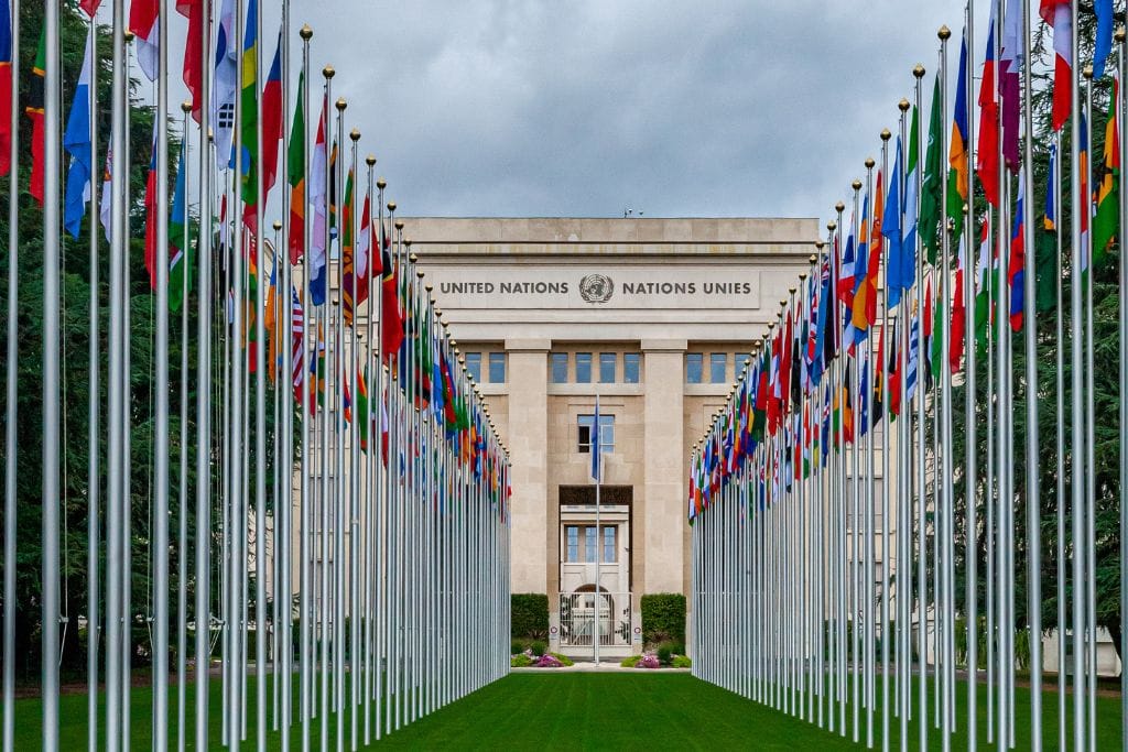 A picture of the united nation headquarter in Geneva. You can find the flag of every member state in the United Nations out front, including the flag of the small country between France and Spain.