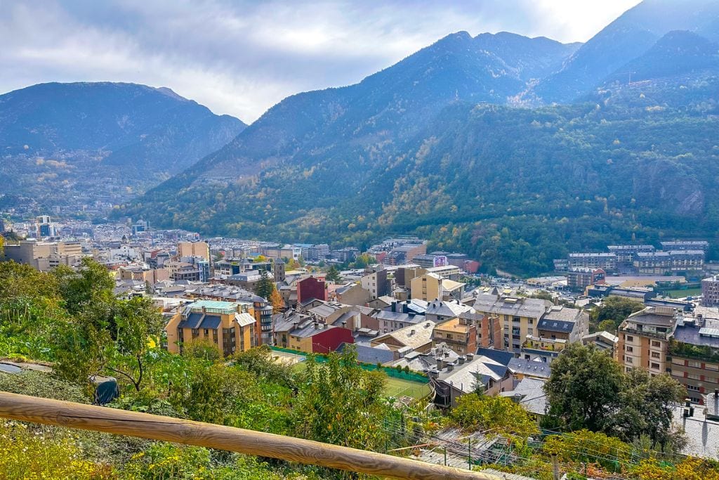 A picture of Andorra and it's towering mountains surrounding the city.