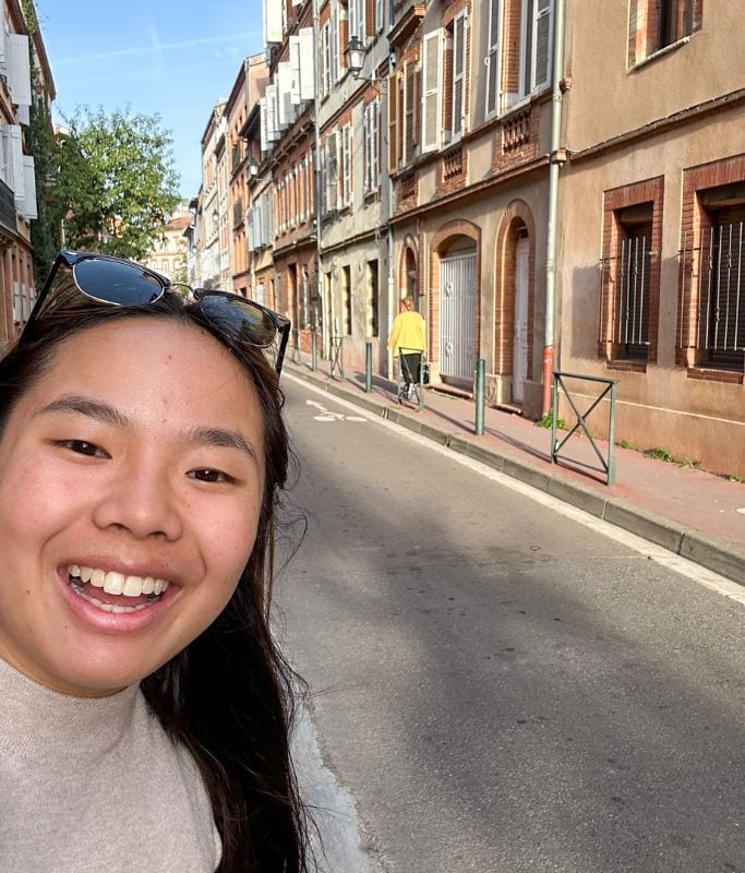 A picture of Kristin smiling while traveling through Toulouse!