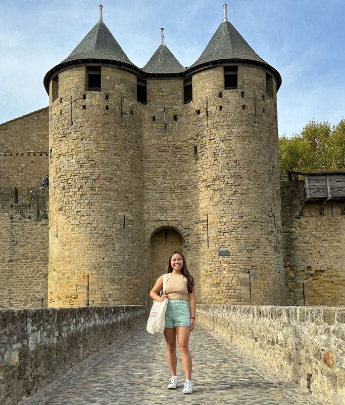 A picture of Kristin in front of Comtal Castle in Carcassonne.