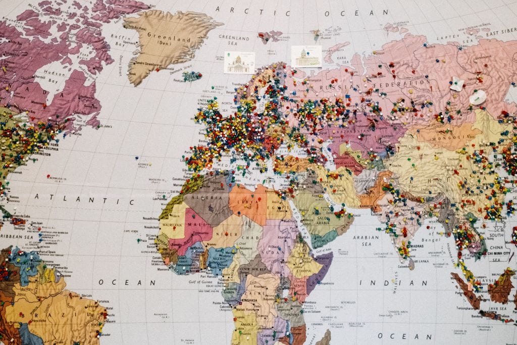 A picture of a world map with lots of pins all over it. Couchsurfing has been around for a long time and has a massive network that makes finding almost free housing much easier.