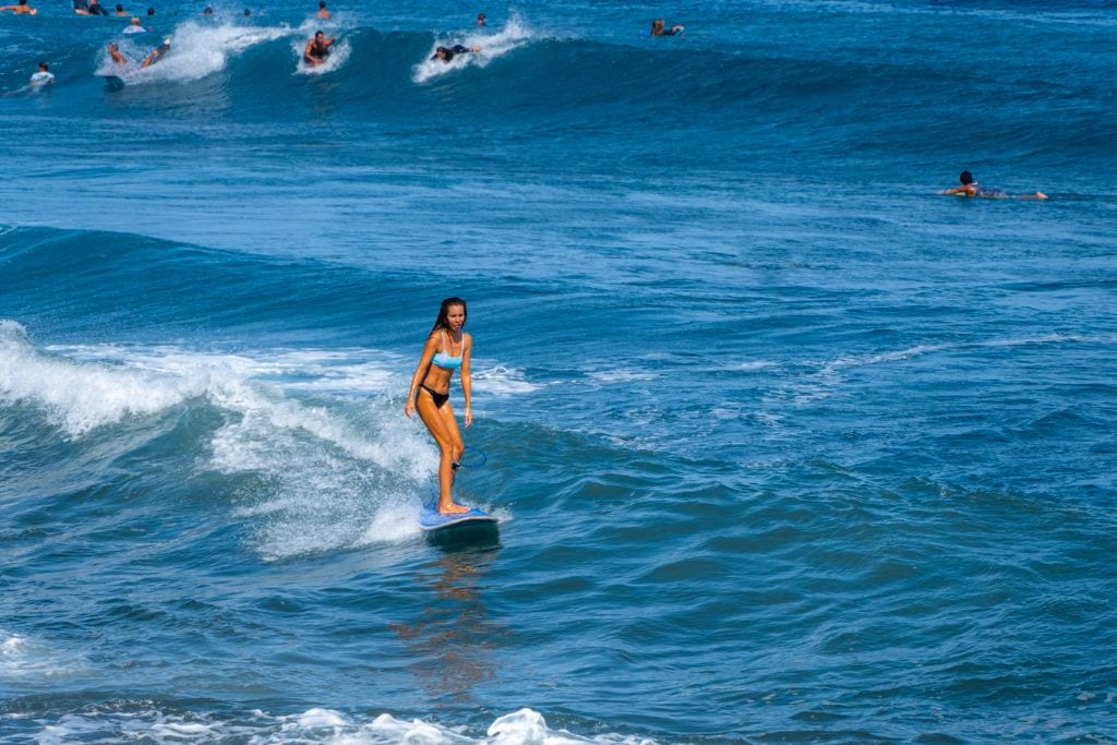 A picture of a local girl surfing at Papara in Tahiti.