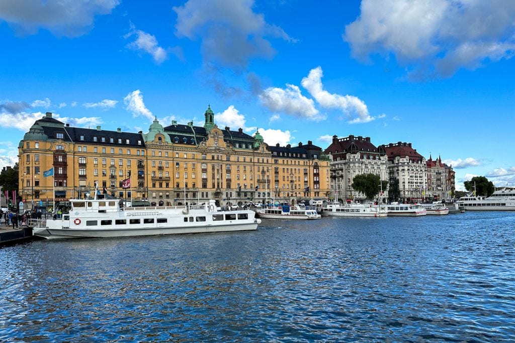 A picture of a museum and some hotels in Stockholm, located along the waterfront. 