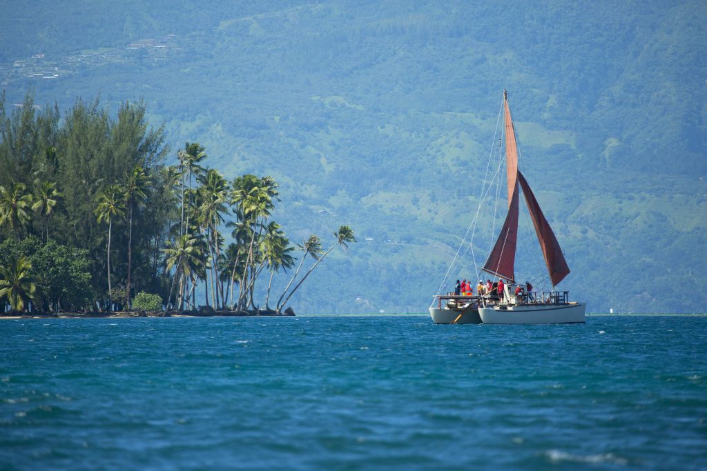 A picture of a boat sailing around Tahiti.
