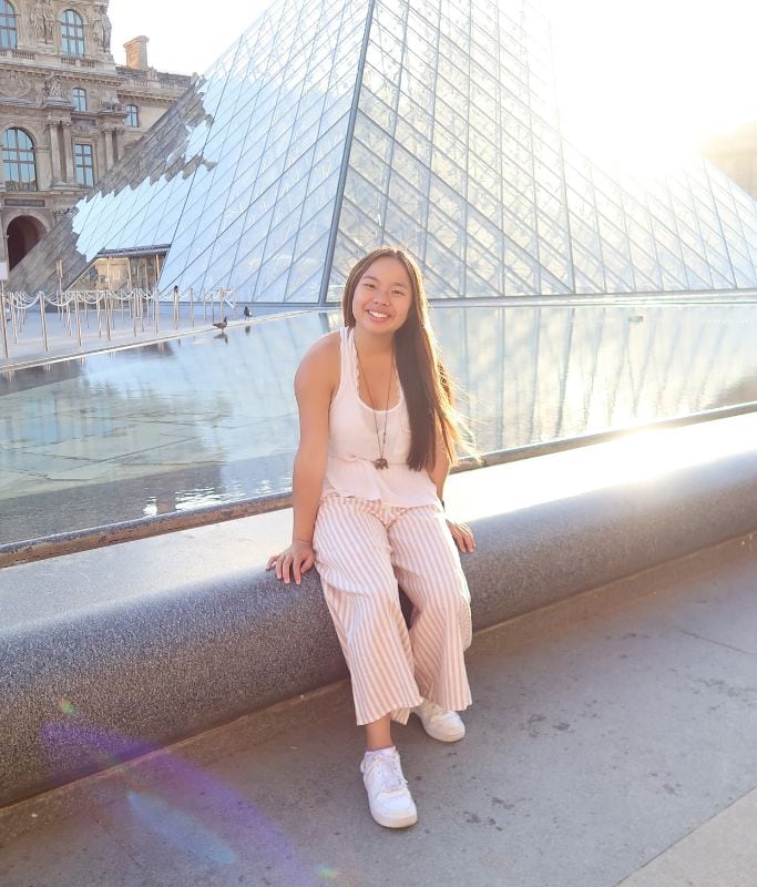 A picture of Kristin in front of the Louvre in Paris.