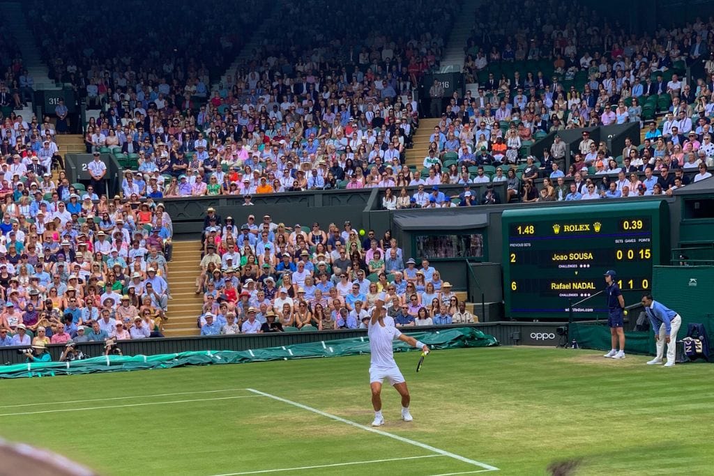 A picture of Rafael Nadal serving on Centre Court at Wimbledon. 