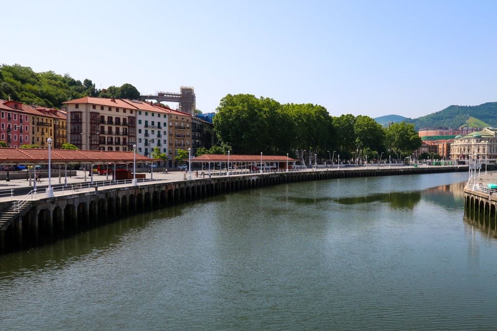A picture of the Nervión River and colorful buildings and architecture on both side.  Bilbao is probably worth visiting for those looking for a laid-back and relaxing getaway for a couple of days!