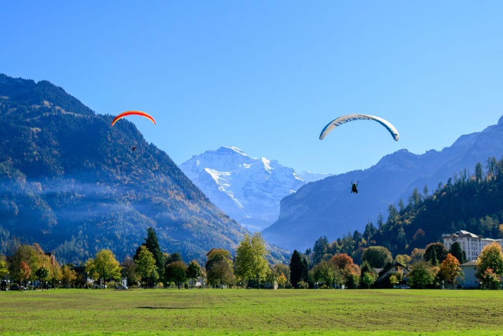 A picture of two people paragliding in Interlaken, Swtizerland.