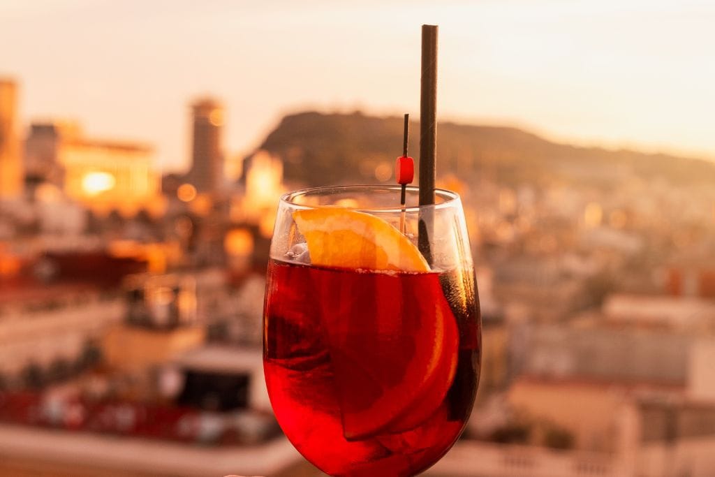 A picture of Sangria with a beautiful view of Barcelona in the background. Several of the tapas tours in Barcelona also include wine tastings, cava, and sangria.
