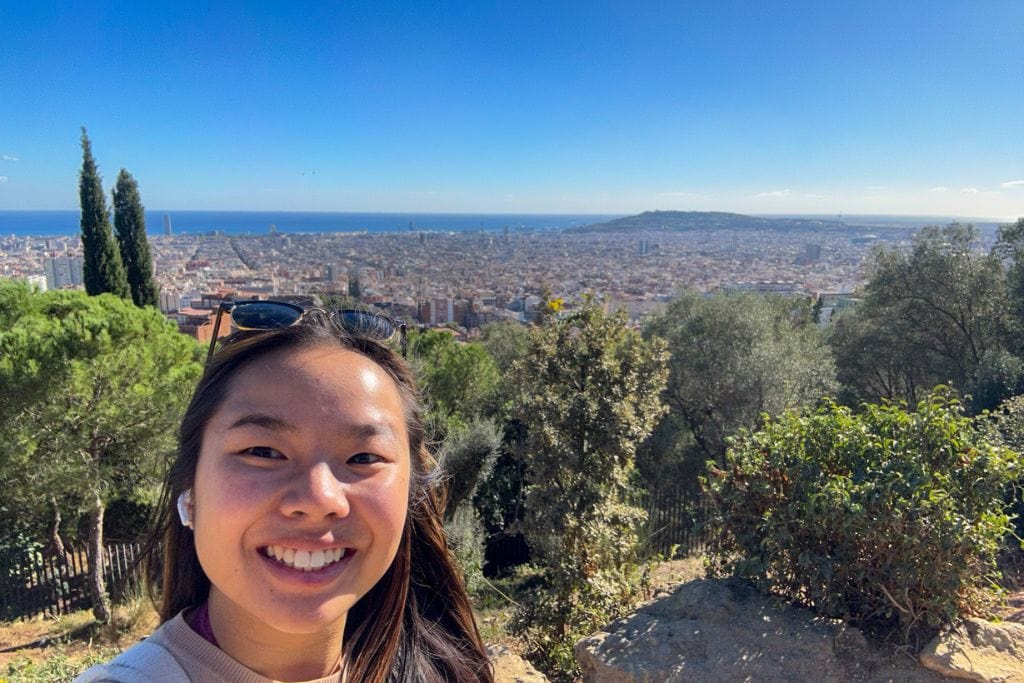 A picture of Kristin with a gorgeous view of Barcelona's cityscape in the background.